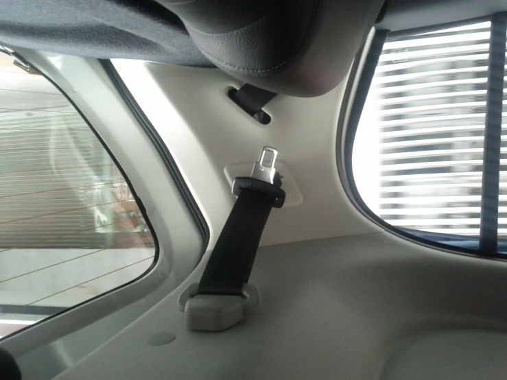 the inside of the rear view mirror has a device hanging from it