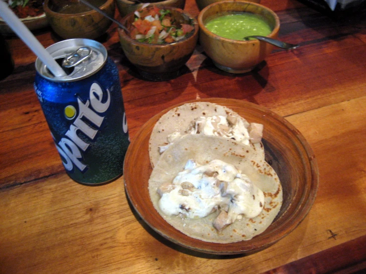 mexican style food and soda on table with condiments