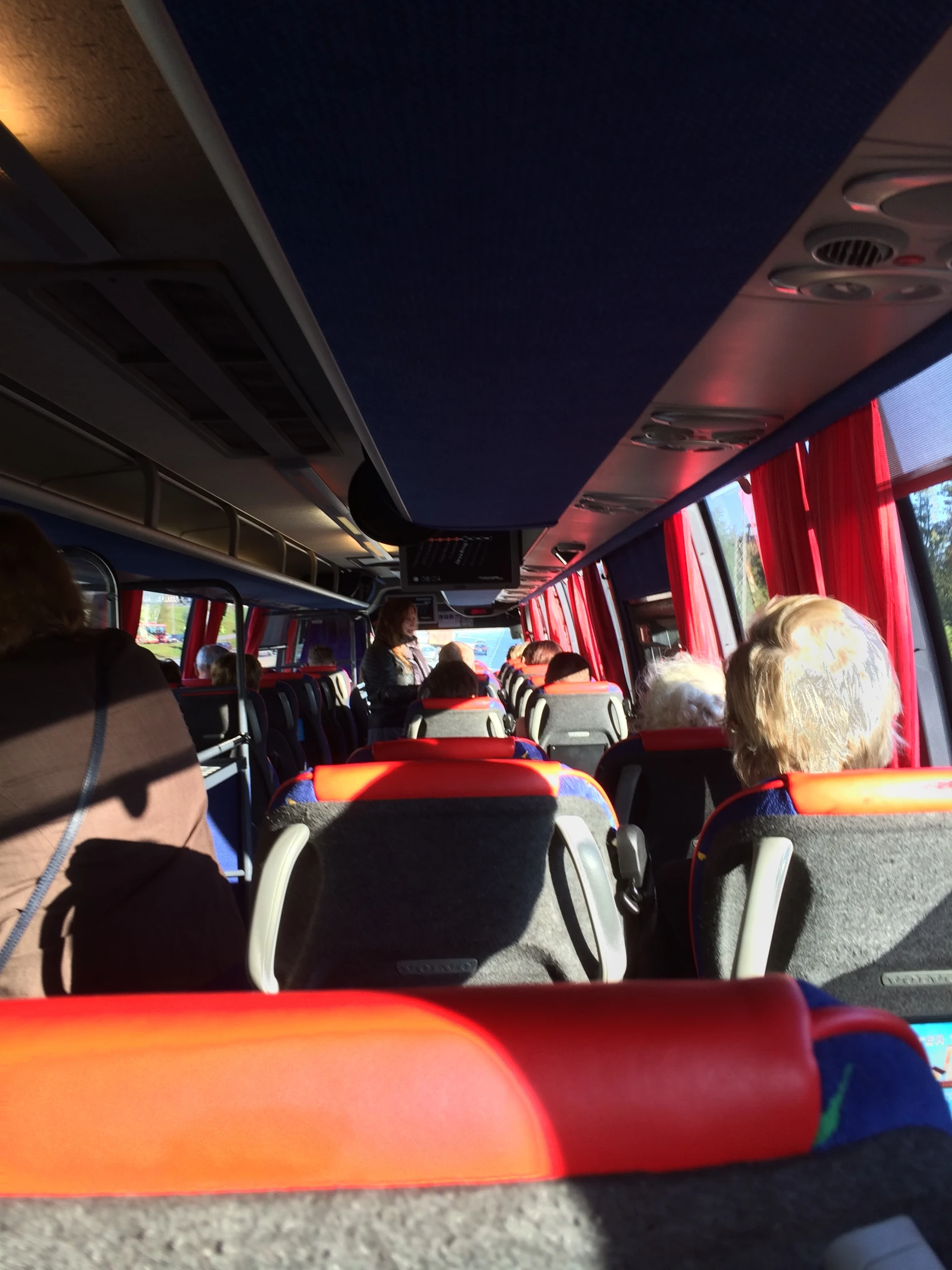 a long bus with the windows covered in red and white