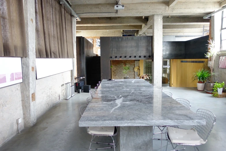 a long concrete table in a large room