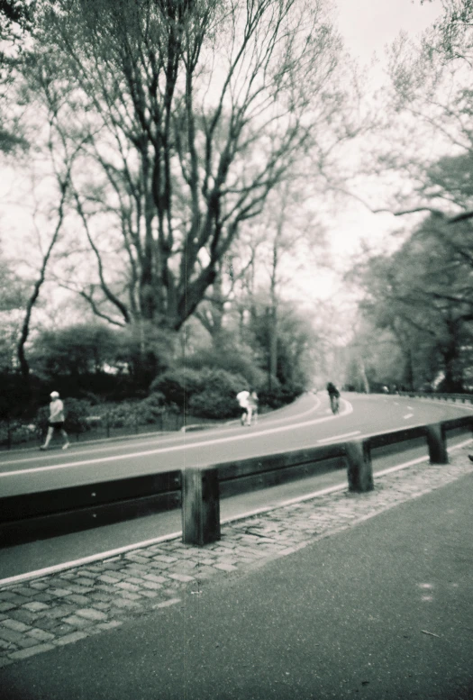 two people are riding bikes while one person rides skate board