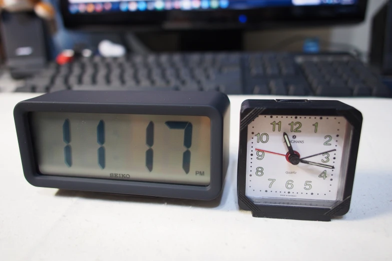 two clock clocks sitting on top of a table