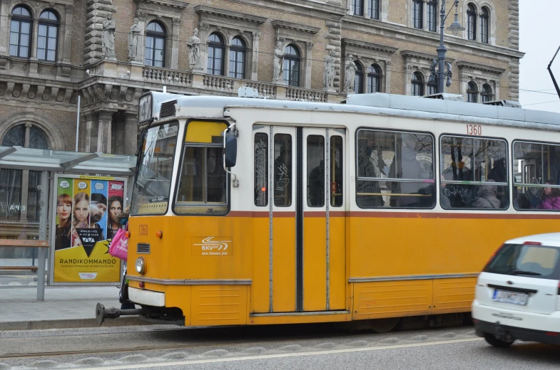 an old style trolley and a van in the city