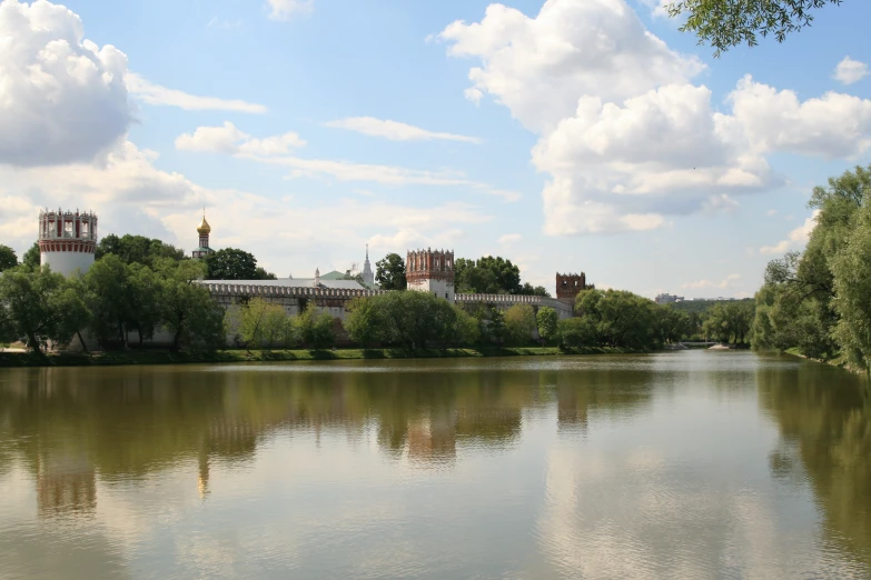 a lake with a building in the distance