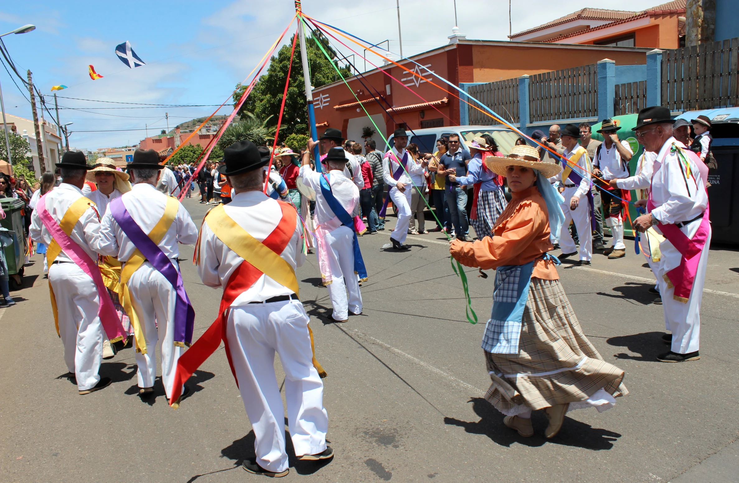 people walking in street with kites in air