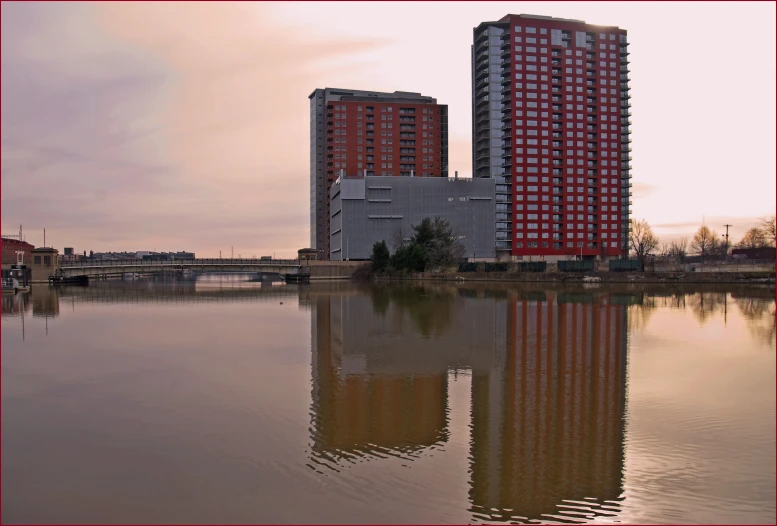 two skyscrs next to one another across the water