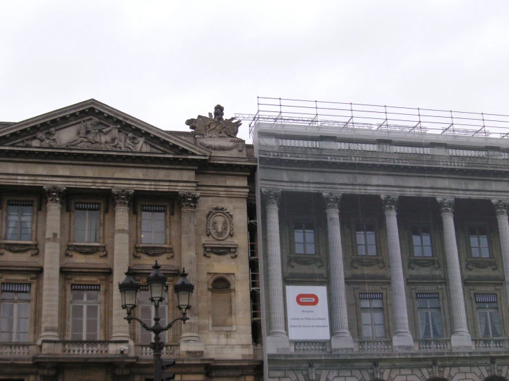 old buildings with ornately decorated pillars and a sign