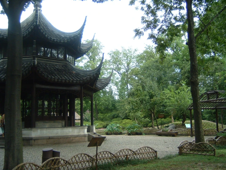 a small asian style pagoda sits near a park