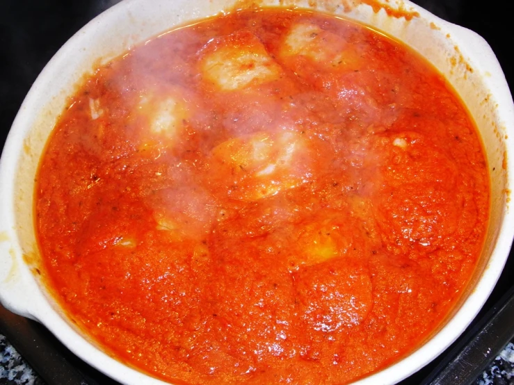 cooked food in a pan is being prepared