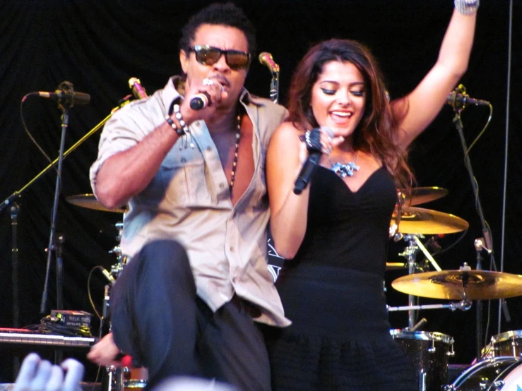 a man standing next to a woman on stage