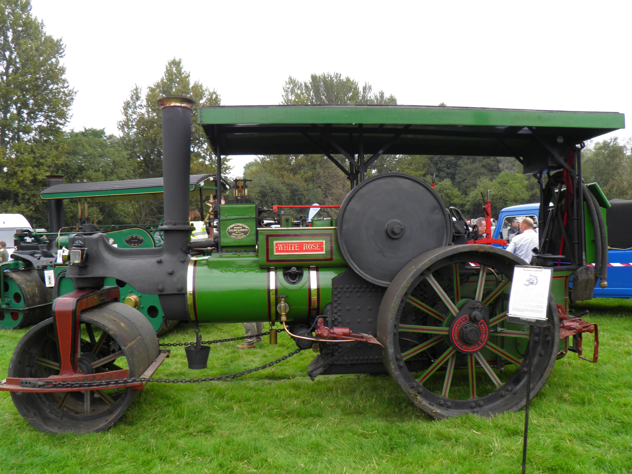 the old, green and black tractor sits on the grass
