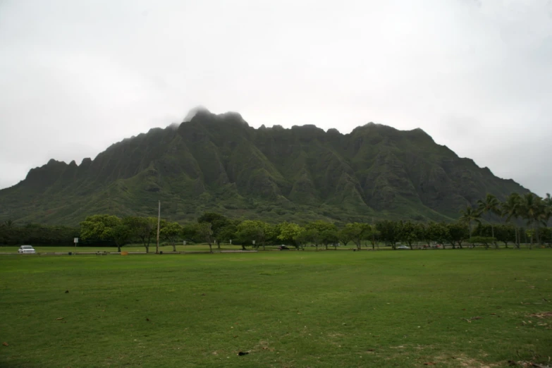 the view of a big mountain out side with some clouds