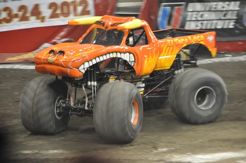 a monster truck in the middle of a dirt race