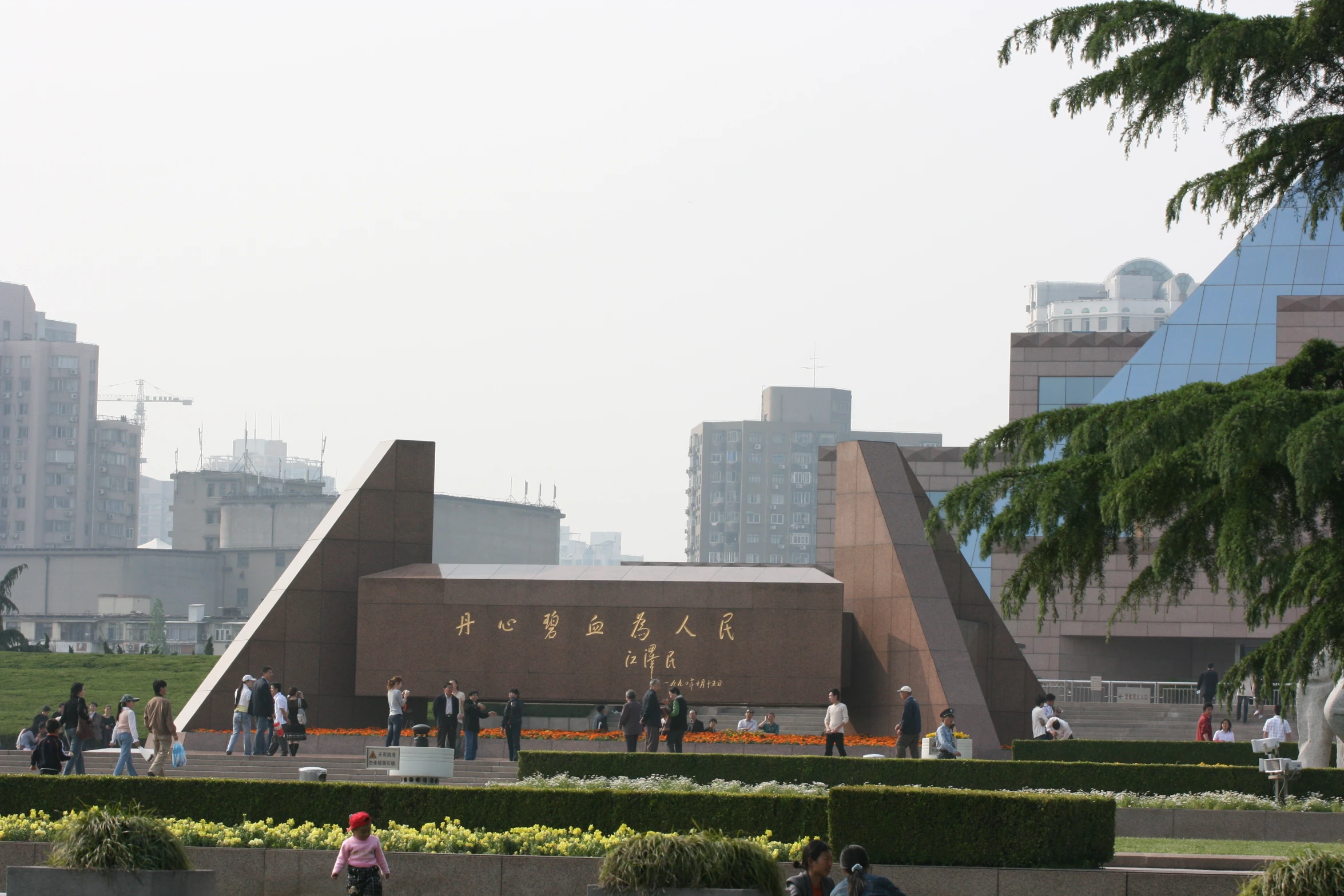 tourists and commuters outside a large modern architecture building