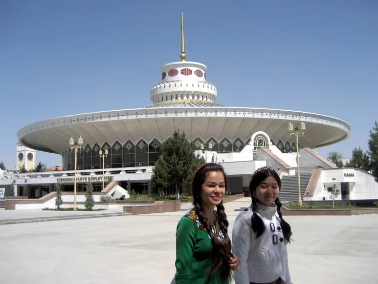 two girls standing in front of a building