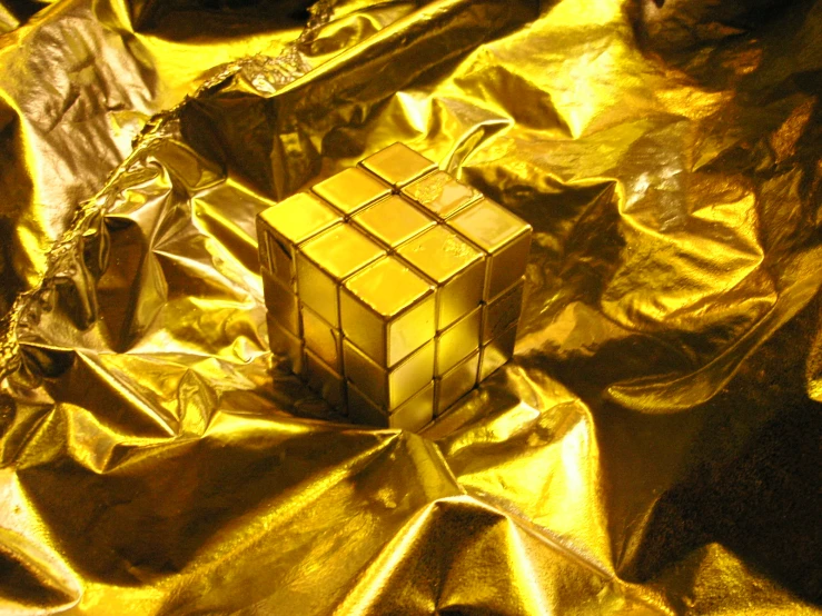 some gold foiled material with a golden square figure