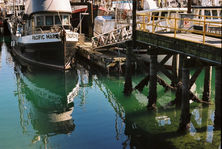 several boats are docked at a harbor in the marina