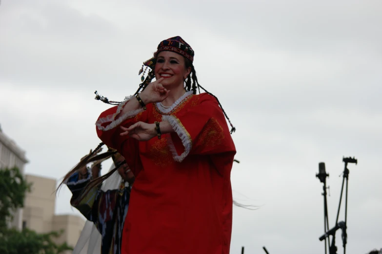 a woman in an indian costume gestures to the crowd