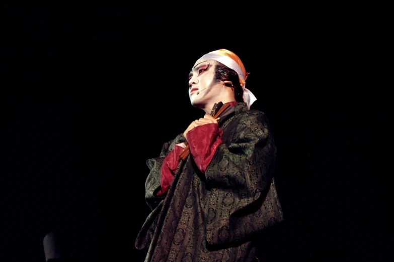 man dressed up in costume performing on stage