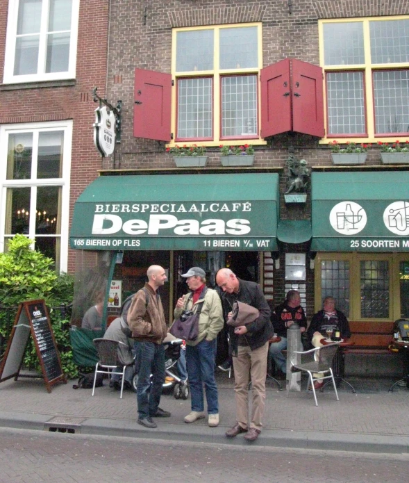 people standing outside of restaurant with the door open