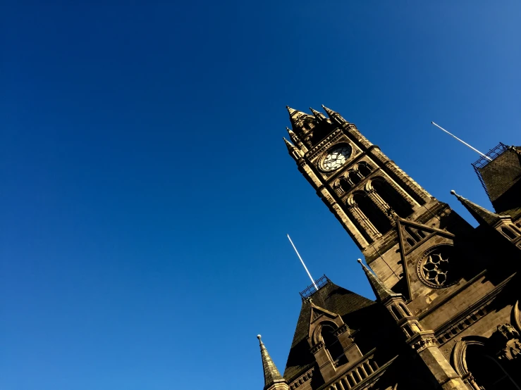 a clock tower that is very tall against a blue sky