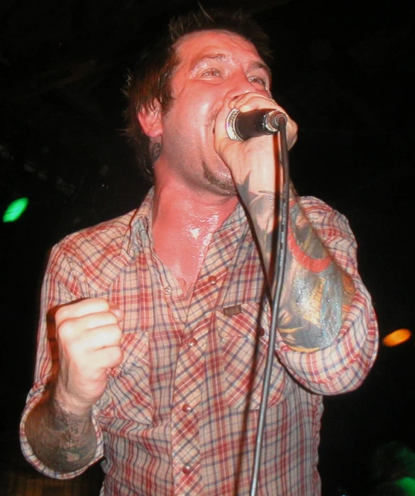 a male singer singing into a microphone