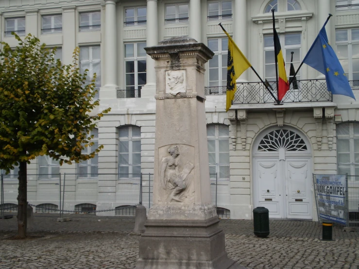 a stone statue sitting on top of a brick road