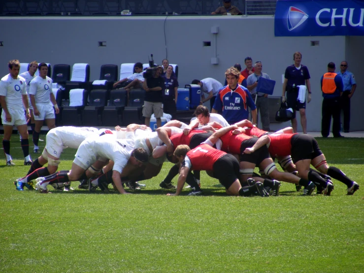 a group of rugby players huddle in a circle