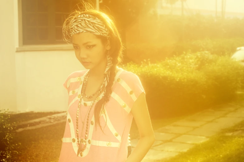 a young lady with a big id in her hair and pink dress