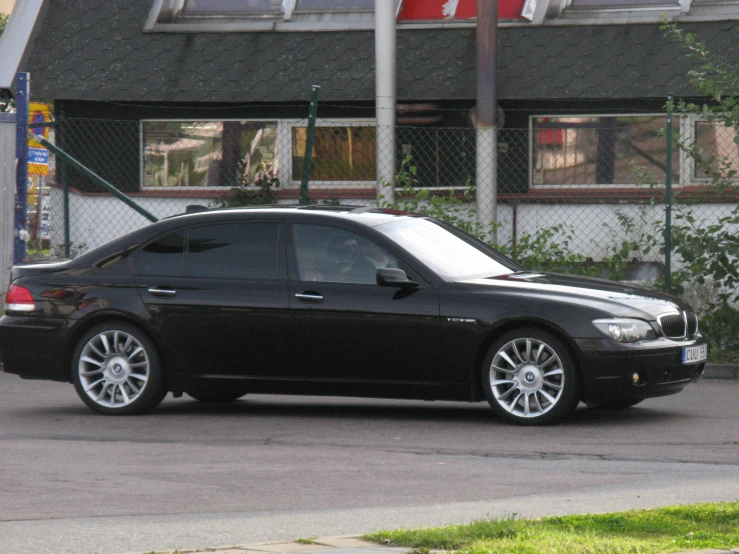 a black bmw sedan with large chrome rims