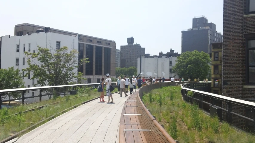 people on a bridge in the city on an overcast day