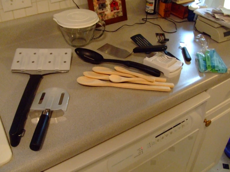 the kitchen counter is littered with items needed for making some pizza