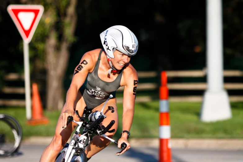 female bicyclist in helmet doing a tight turn