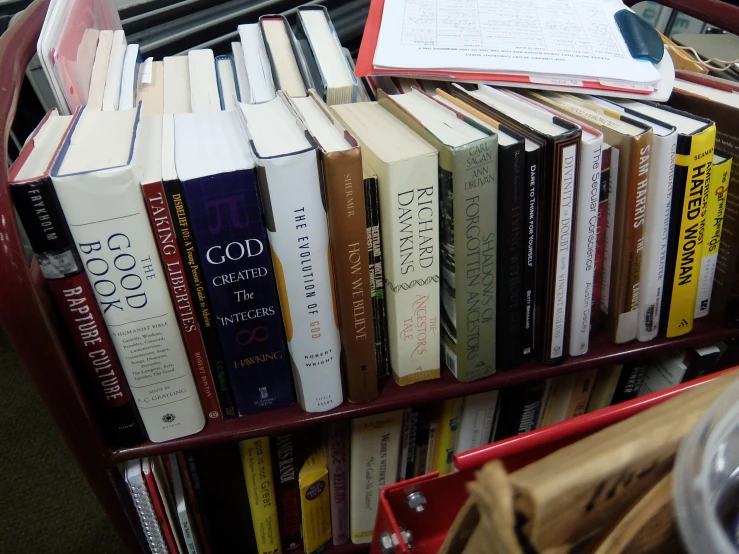 a red book cart filled with lots of books