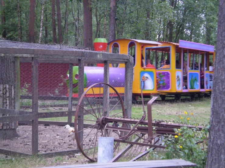 there is a colorful train going by in the yard