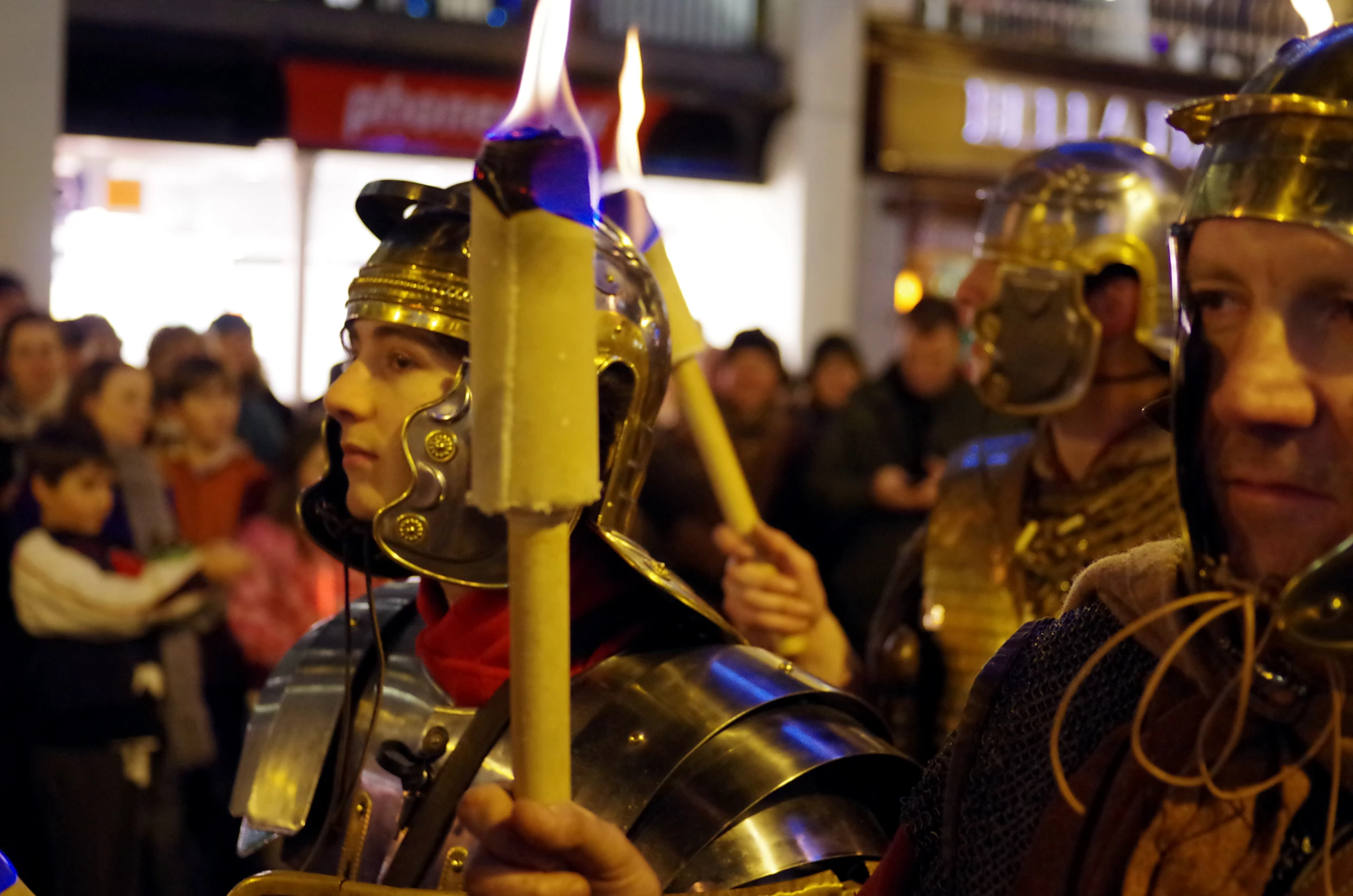 two people dressed up as knights holding torches