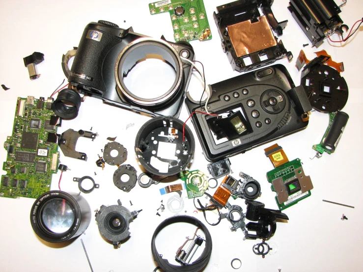 many electronics pieces including a mirror, camera, and several wires