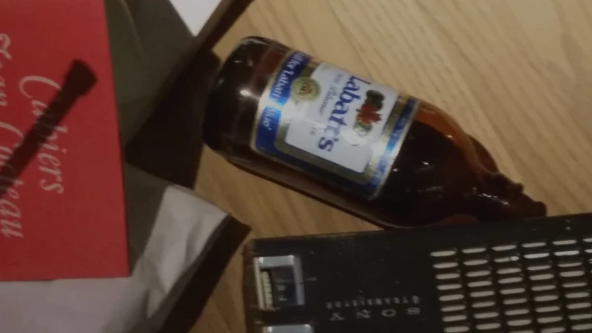 a bottle of liquor sitting on top of a wooden table