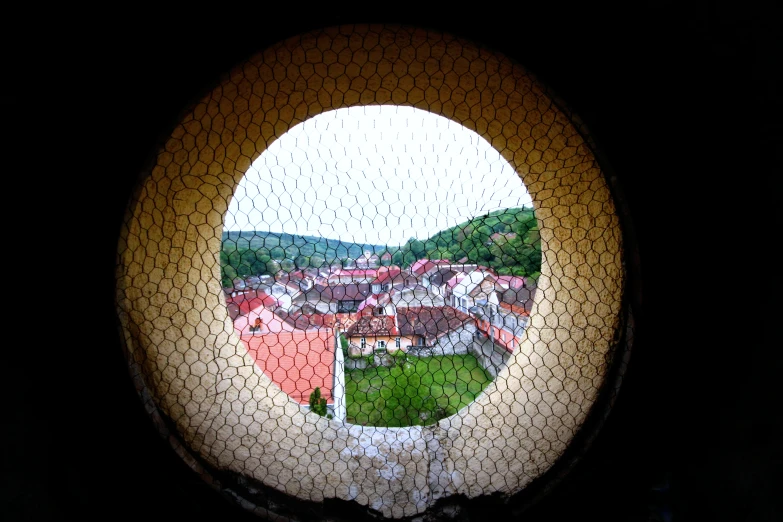 a circle shaped window view looking out at an old town