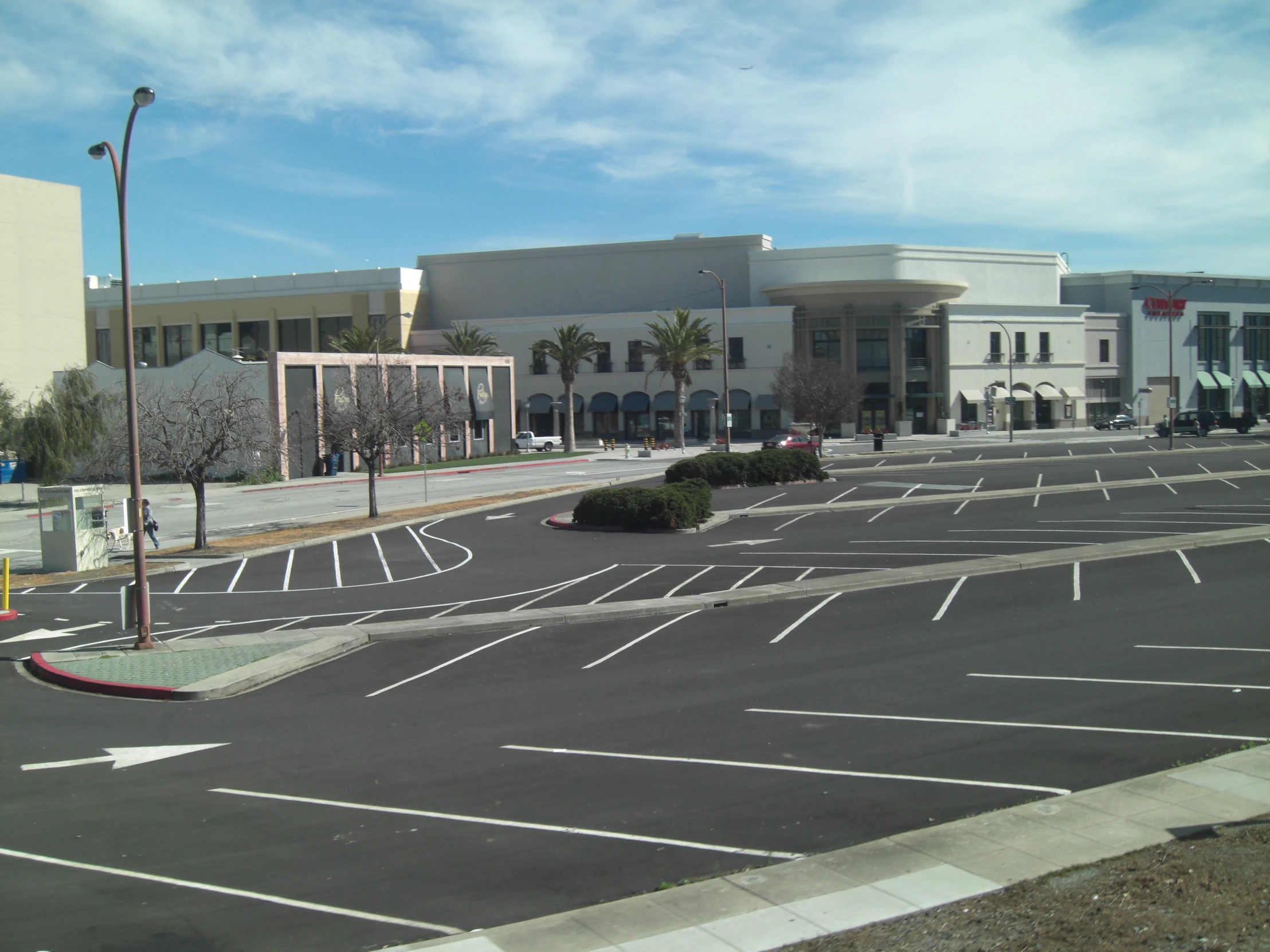 a parking lot with empty cars in front of it