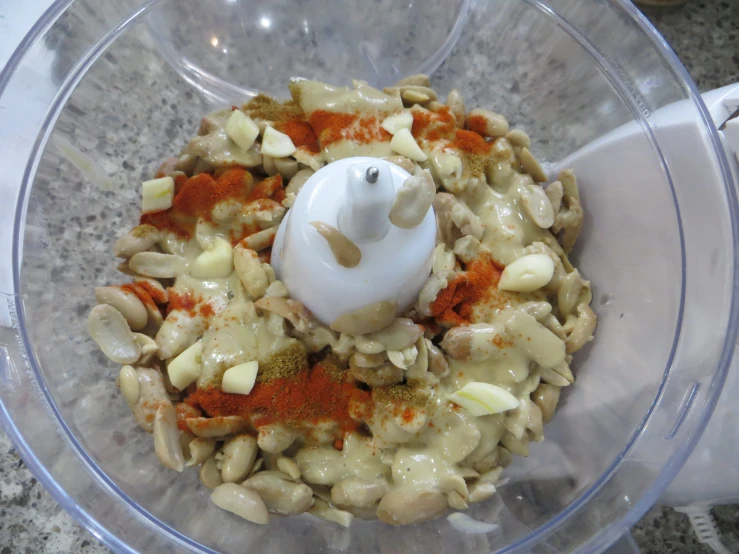 food is shown in a blender with spices