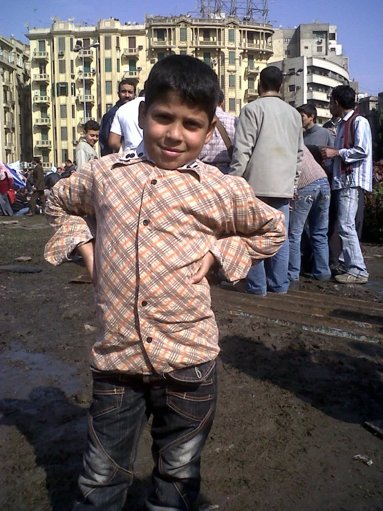 a  standing in the mud near many buildings