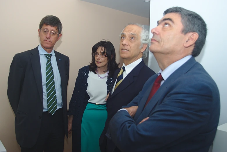 there are five men standing together in an elevator