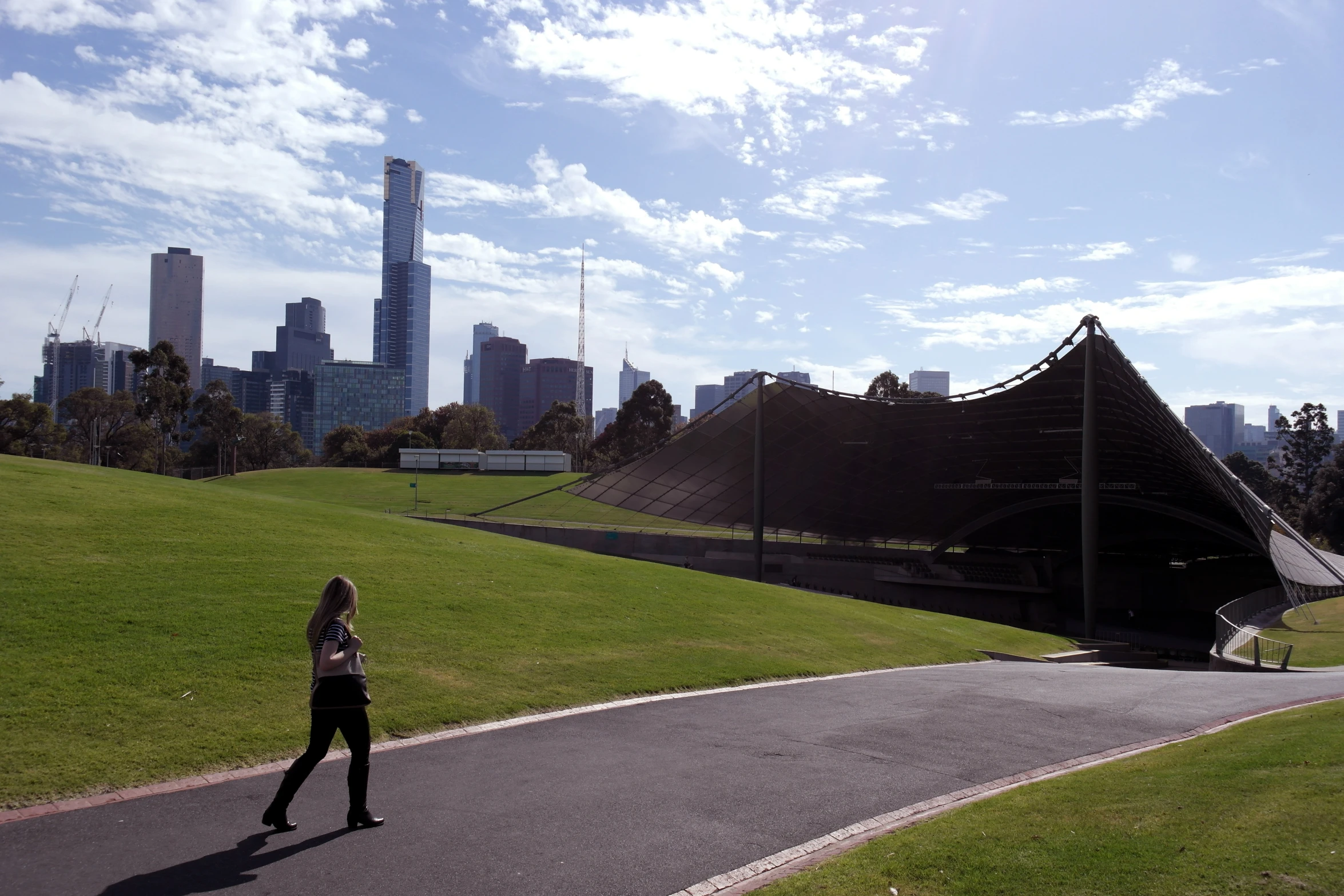 a man that is standing in the grass near a fence