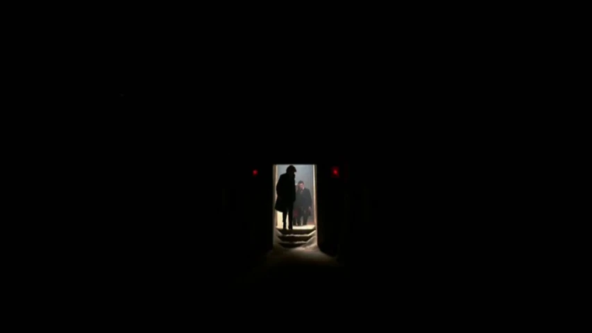 two people walking out of a dark tunnel