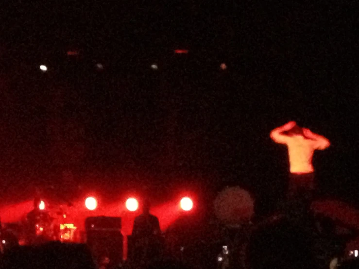 people standing on stage with a microphone and a man in the middle of it