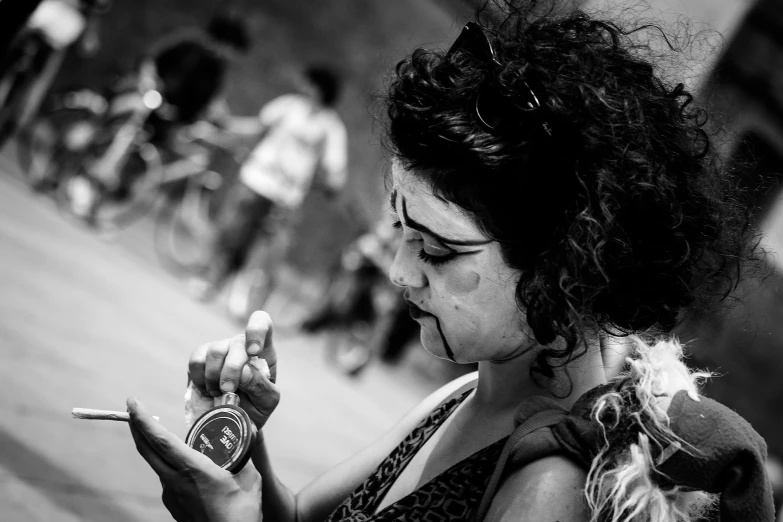 a woman holding a cell phone and smoking a cigarette