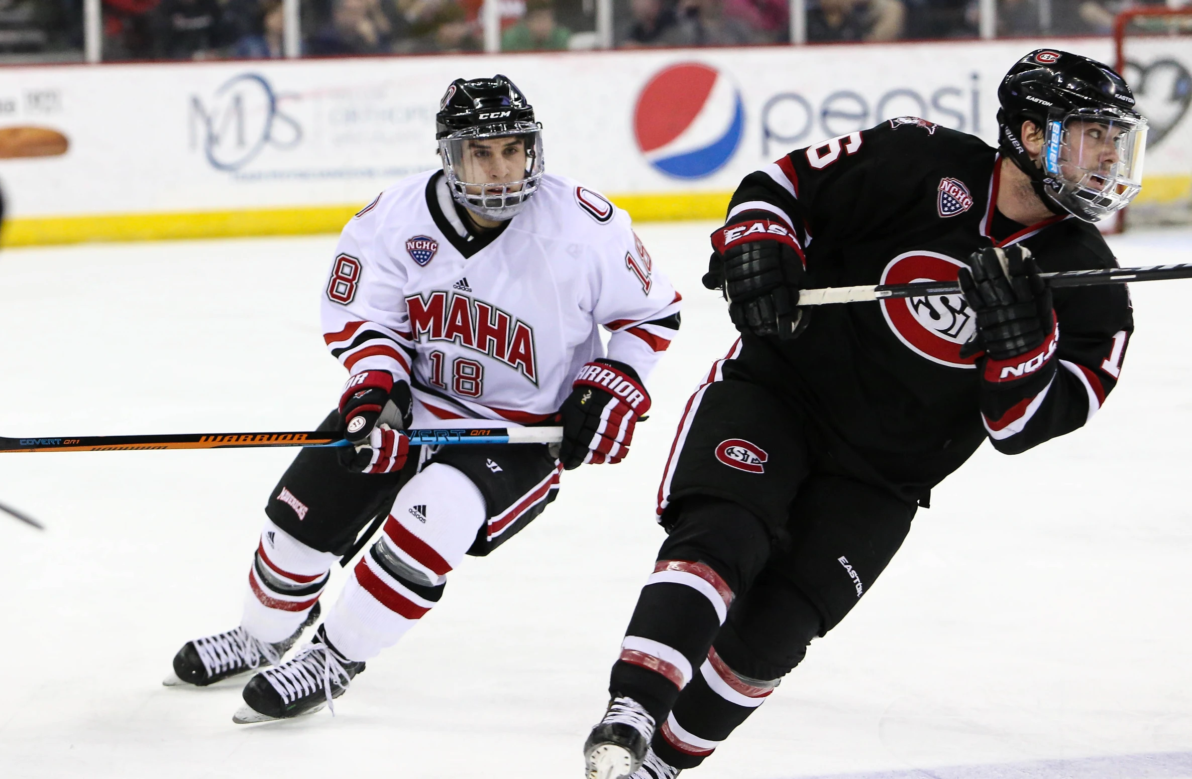 two hockey players on the ice playing hockey