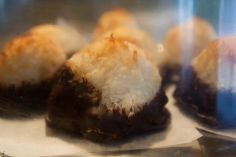 a bunch of chocolate and coconut treats are on display