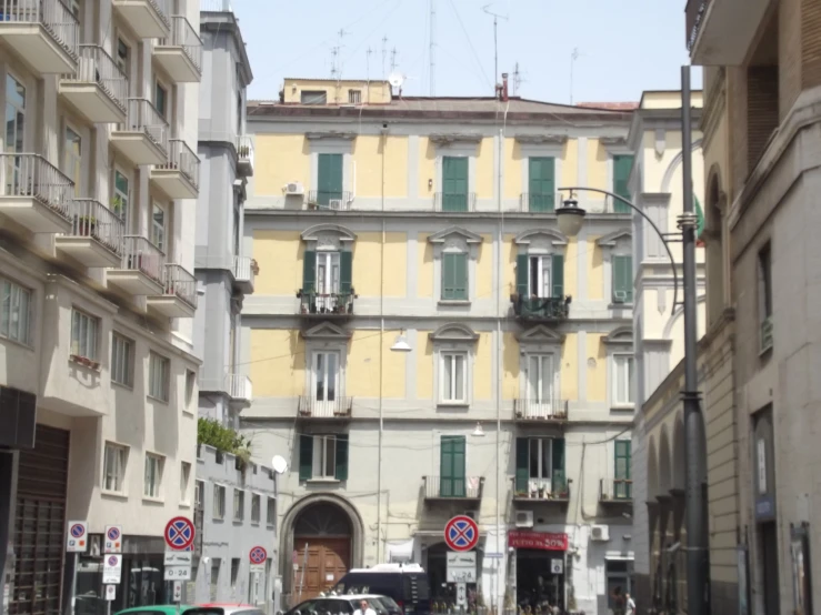 a narrow street is shown with parked cars